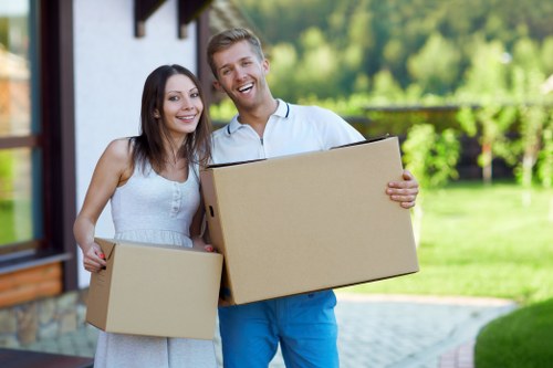 House removal team carrying furniture through a Camden property