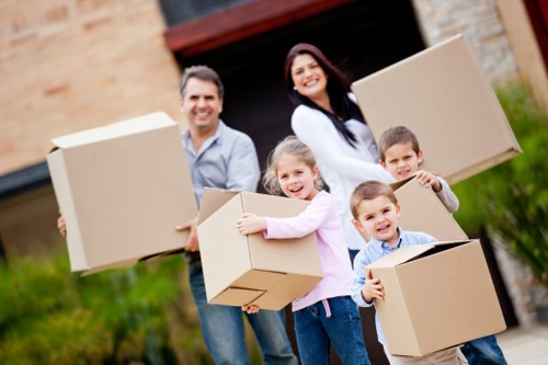 Stacked cartons and wrapped furniture prepared for relocation