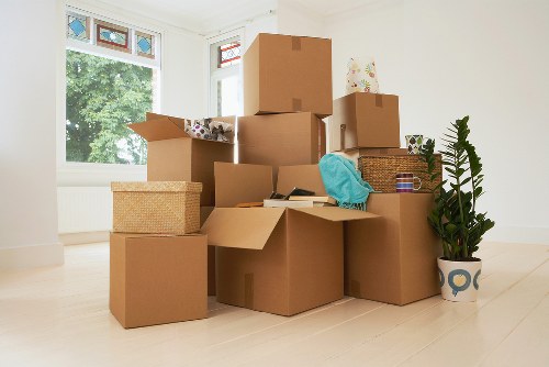 Mover carrying a boxed item carefully through a doorway